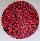 ceramic sculpture of geometric sphere red sprigged poppies on blue glazed surface one side blue poppies on red other side