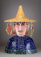 Ceramic Sculpture of Chinese Kitchen God with food items hanging from hat, created by ceramic sculptor Antonia Lawson