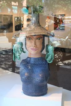 Ceramic sculpture of village deity wearing Hakka hat with bunches of Bak Choi